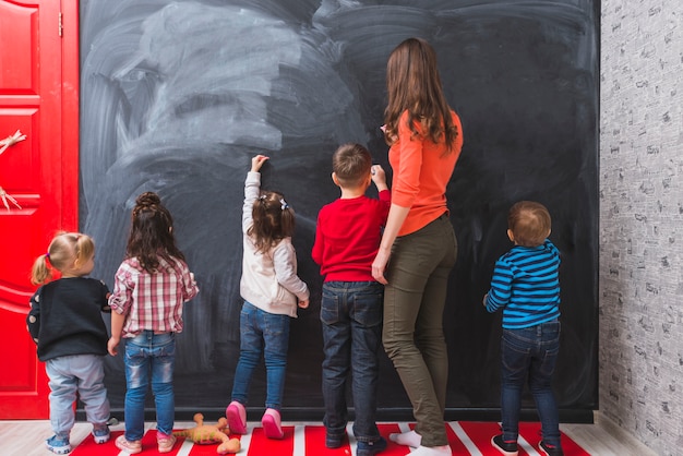 Woman and children drawing chalk