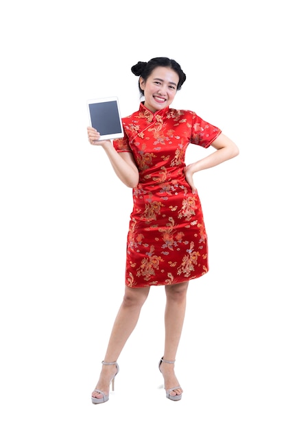 Woman in Chinese long dress, presenting blank tablet screen