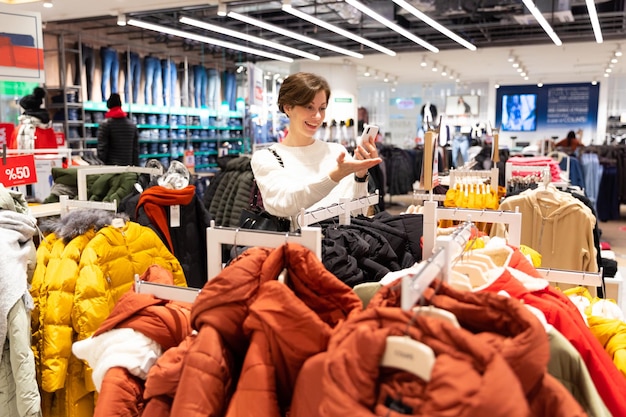 Woman chooses clothes during discounts in the mall