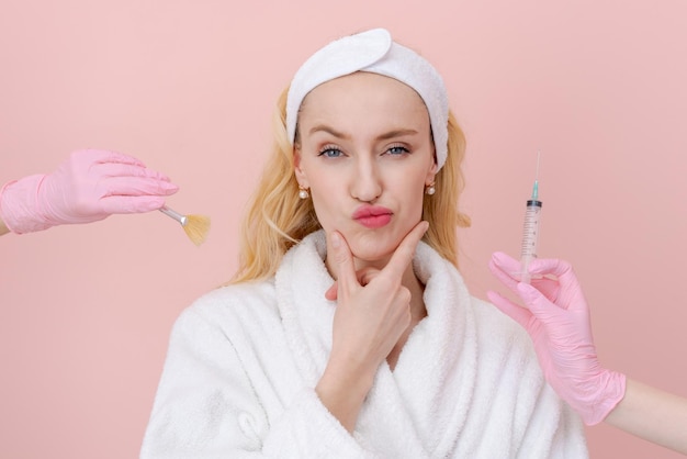 Woman chooses facial care procedure on both sides gloved hands reach out