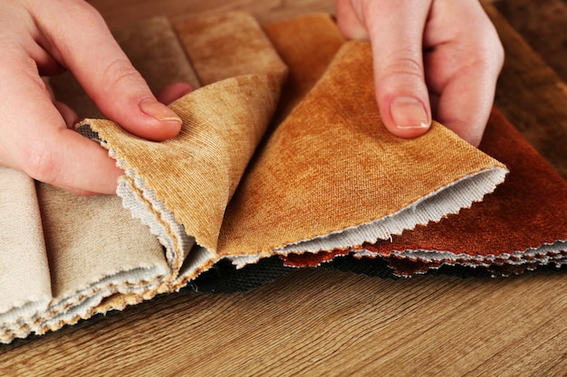 Woman chooses scraps of colored tissue on table close up