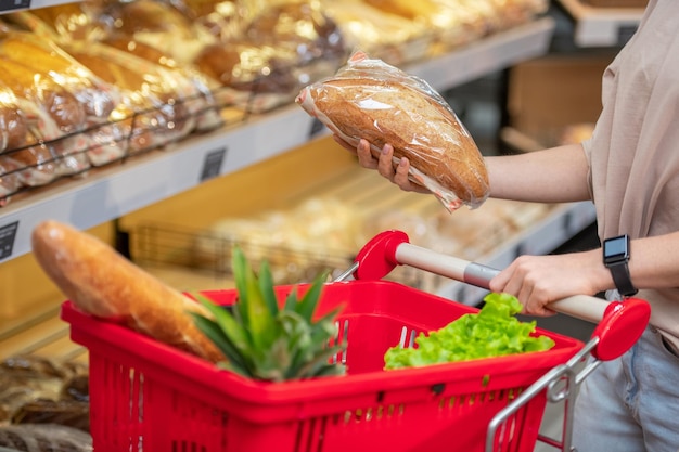 Woman choosing bread in store