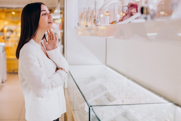 Woman choosing jewelry at jewelry store