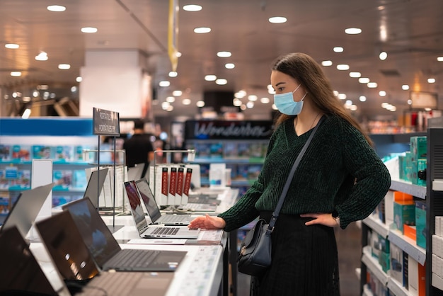 Photo woman choosing laptop in mall