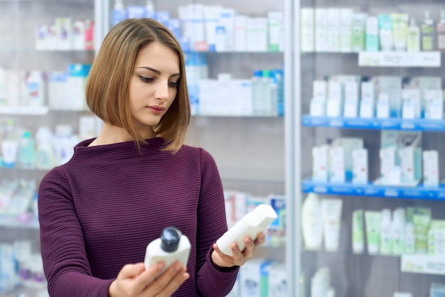 Woman choosing medical products in drugstore