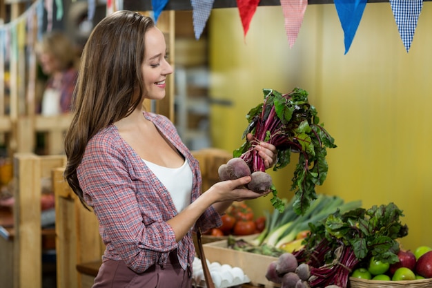 Woman choosing vegetables in grocery store