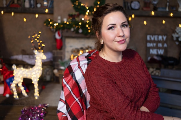 Woman on christmas eve at home in new year interior