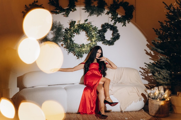 Woman on the Christmas interior background Portrait of a beautiful brunette woman with evening makeup