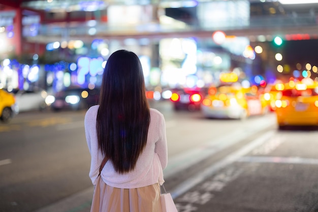 Woman in the city at night