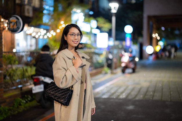 Woman in the city at night