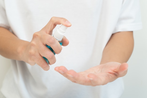 Woman clean hand with alcohol gel