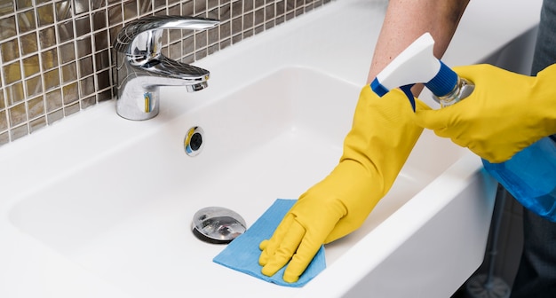 Woman cleaning bathroom sink