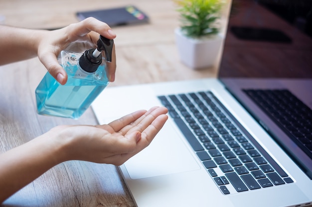 Woman cleaning hands with sanitizer