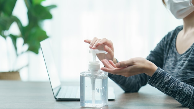 Woman cleaning her hands with sanitizer