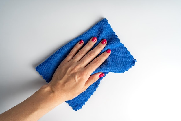 A woman cleaning the house by the blue micro fibre cloth