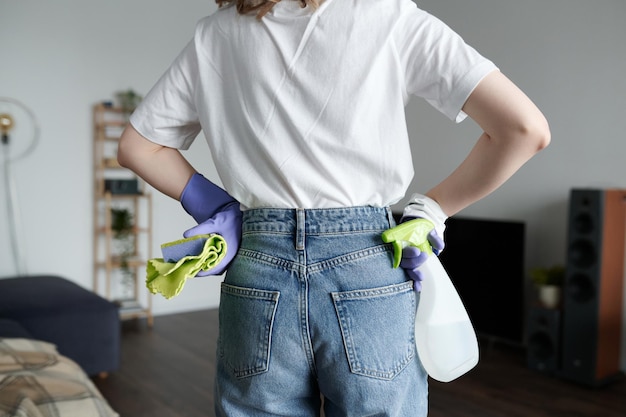 Woman cleaning the room with detergent