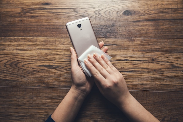 Woman cleaning smart phone