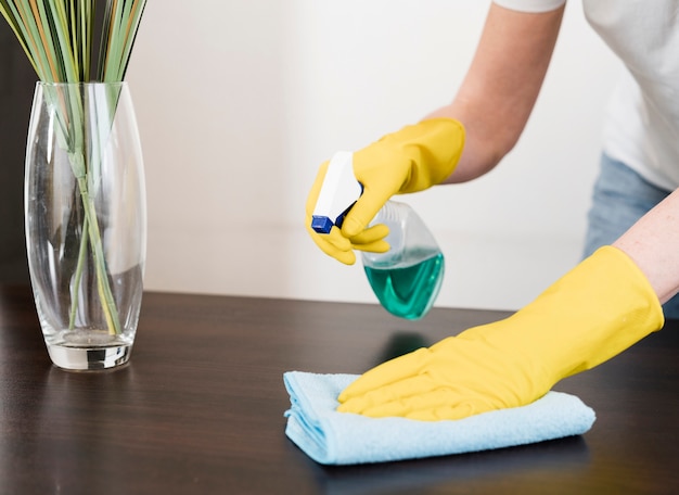 Woman cleaning the table with rag