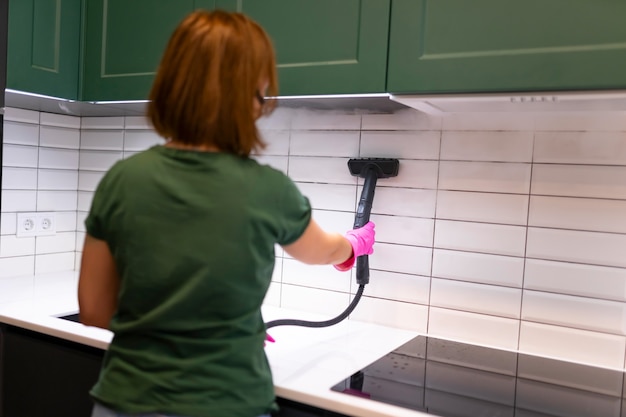 Woman cleaning tiles in the kitchen