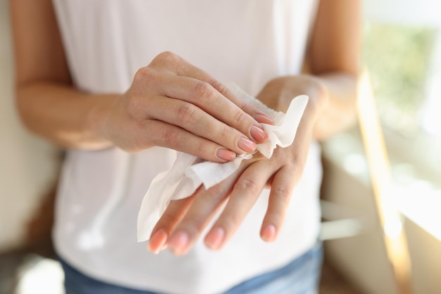 Woman cleans hand with wet wipes close up