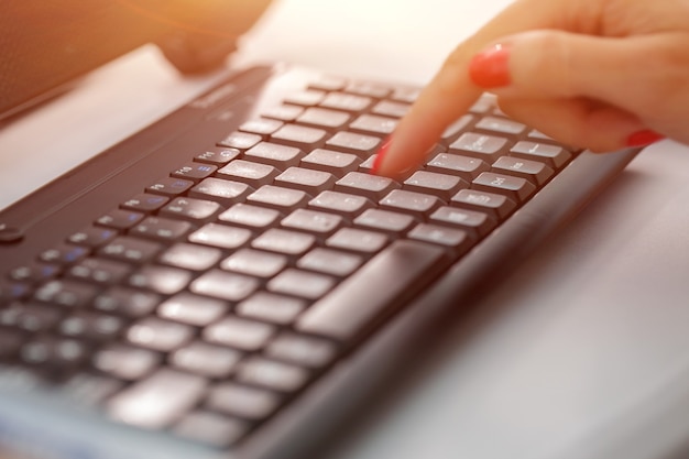 A woman clicks on internet search pages on computer keyboards to find what they are interested in to...