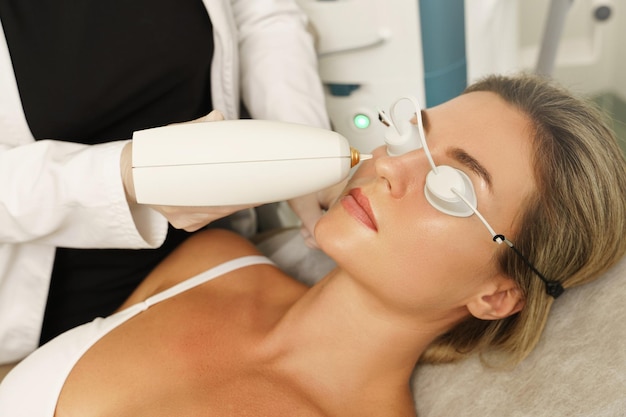 Woman client during IPL treatment in a cosmetology medical clinic