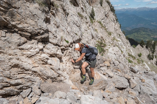 Woman climbing mountain backpacker