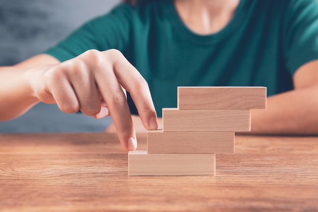 Woman climbing the wooden stairs with her fingers