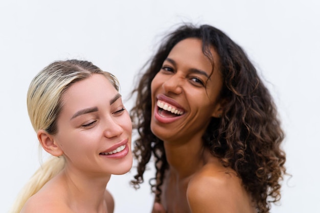 Woman close beauty portrait mixed race black skin and white skin two female on white background