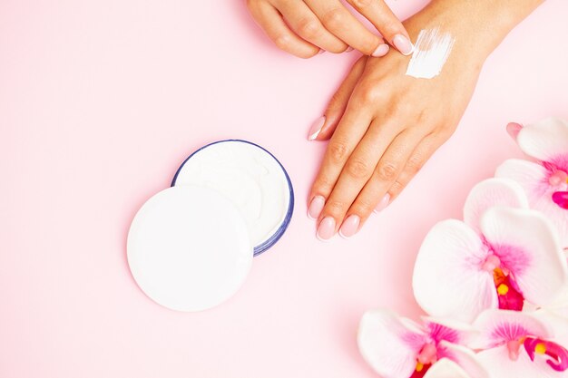 Woman close up applies moisturizer for hand skin care