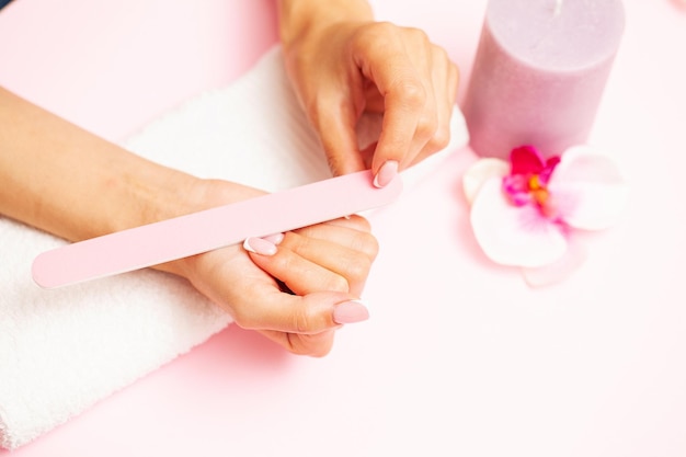 Woman close up of doing manicure on hands.