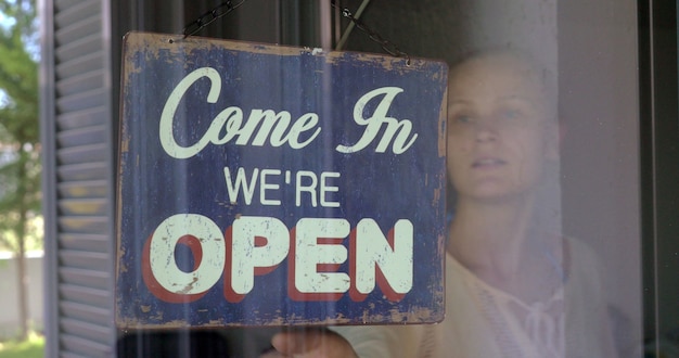 Woman closing the shop or cafe