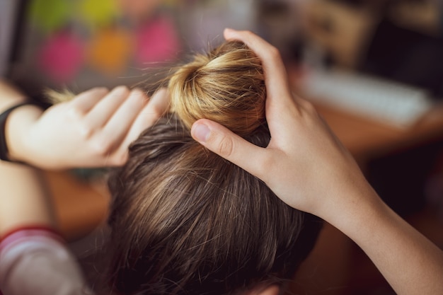 Woman collecting hair in hair salon