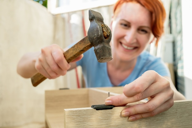 The woman collects furniture in the apartment Housework DIY