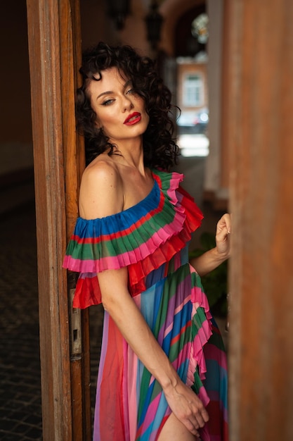 Woman in a colorful dress with a red lipstick