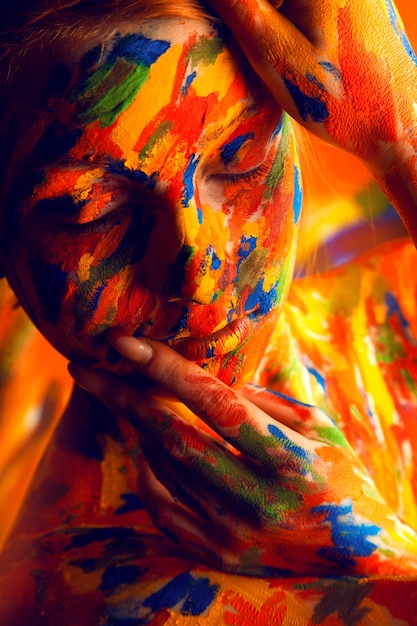 Woman in colourful paint on skin