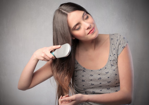 Woman combing her hair