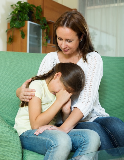 Woman comforting  crying daughter 