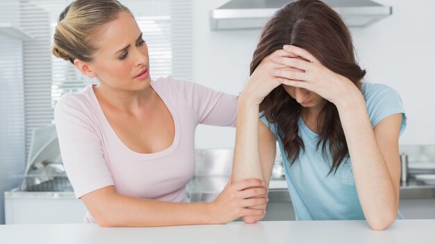 Woman comforting her upset friend