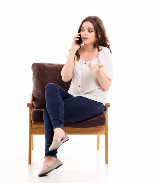 A woman communicates on a mobile phone