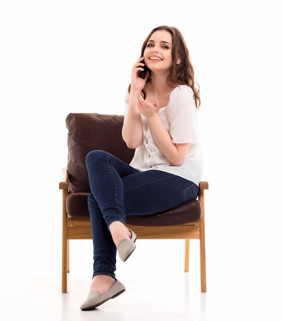 A woman communicates on a mobile phone