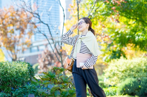 A woman commuting in office casual style on fine day