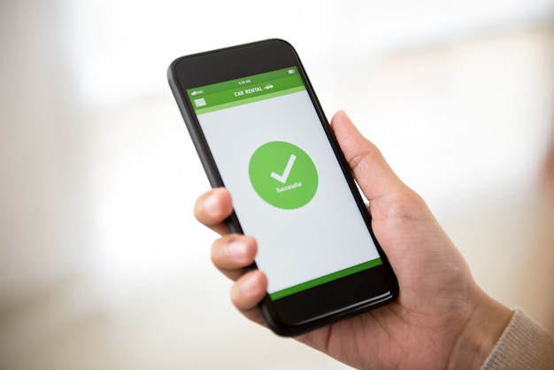 Woman completing car rental booking on smartphone