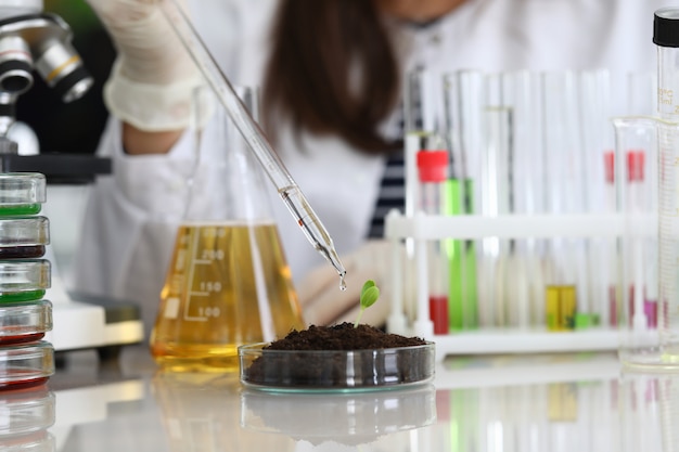 Woman conducts chemical analysis fluid samples