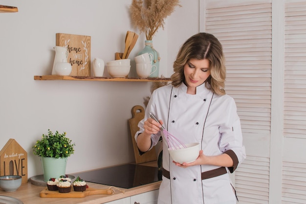 Woman confectioner or cook with whisk