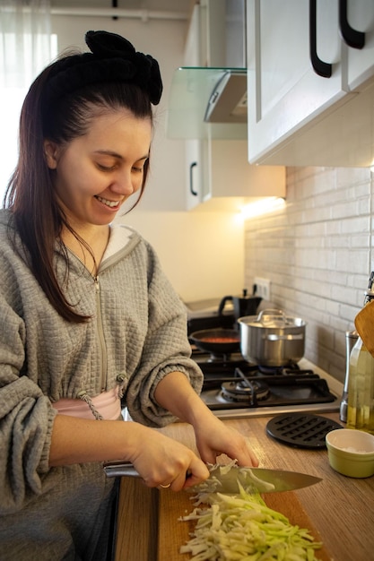 Woman cooker at domestic kitchen preparing food