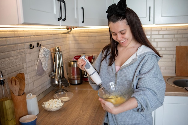 Woman cooker at domestic kitchen preparing food