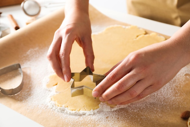 Woman cooking cookies using different cookie cutters