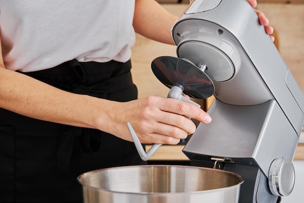 Woman cooking at preparing food using food processor