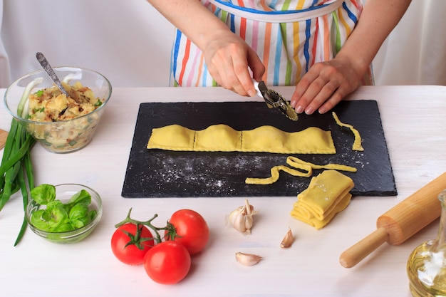 Woman cooking traditional homemade Italian ravioli